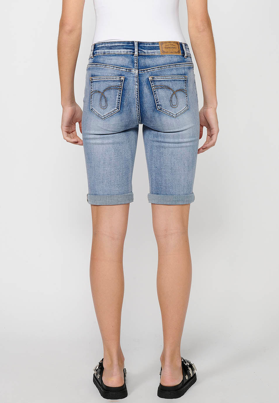 Pantalón corto short acabado en vuelta con detalles de parches delanteros y cadena adorno extraíble con cierre delantero con cremallera y botón para mujer | moda actual