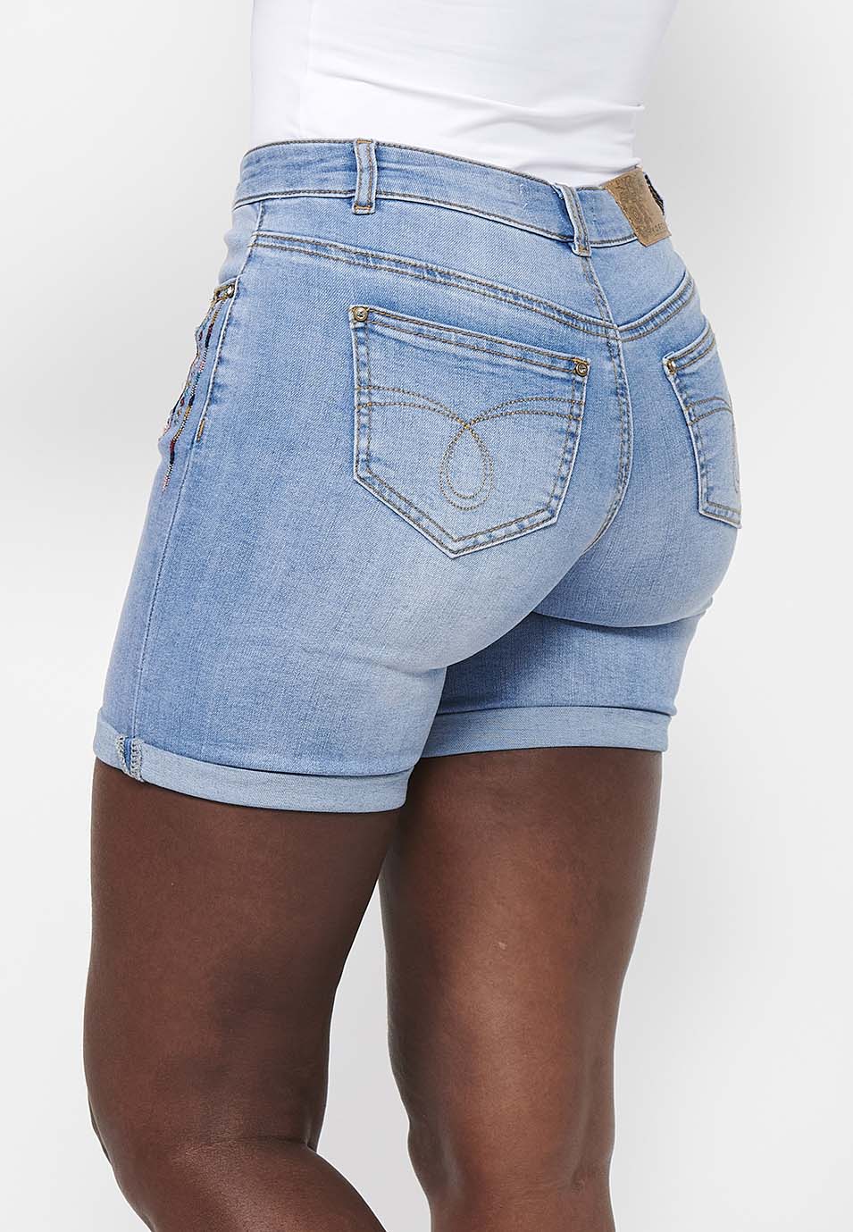 Pantalón corto short acabado en vuelta con cierre delantero con cremallera y botón con detalles bordados para mujer | moda actual
