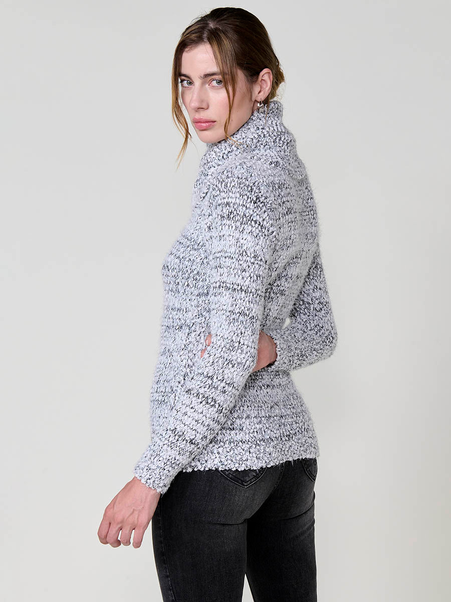 Jersey de mujer con pelo de tacto suave, cuello alto, textura bicolor en hilo chenilla y placa metálica koröshi.