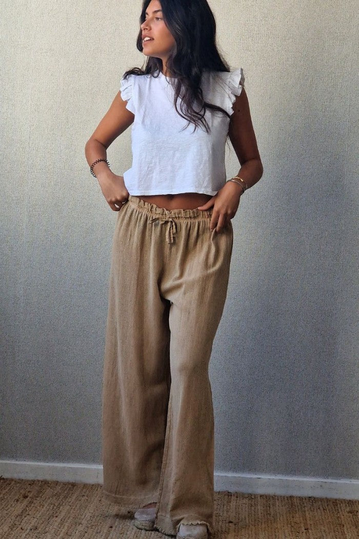Pantalón tipo lino flecos camel
